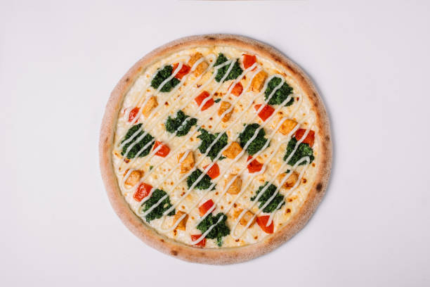 istock Pizza with chicken, paprika and spinach on white. Top view 950690348