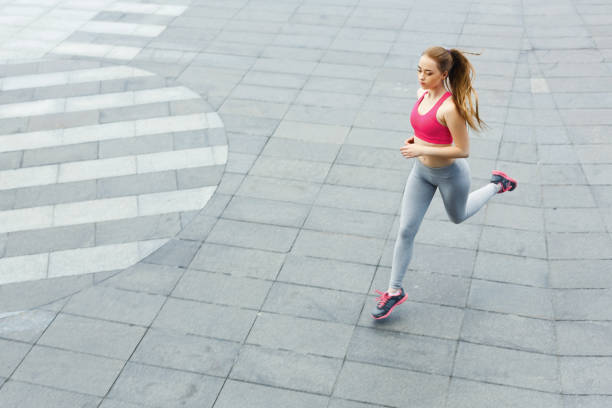 istock Young woman jogging in city copy space 950694924