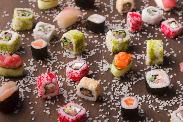 istock Assortment of colorful sushi and rolls background 950698444