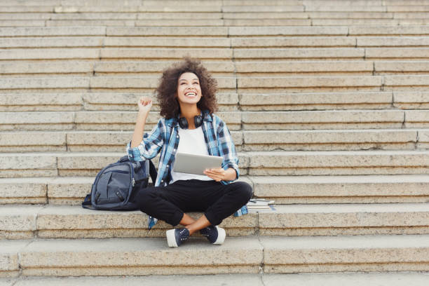 istock Happy young woman using digital tablet outdoors 950711964