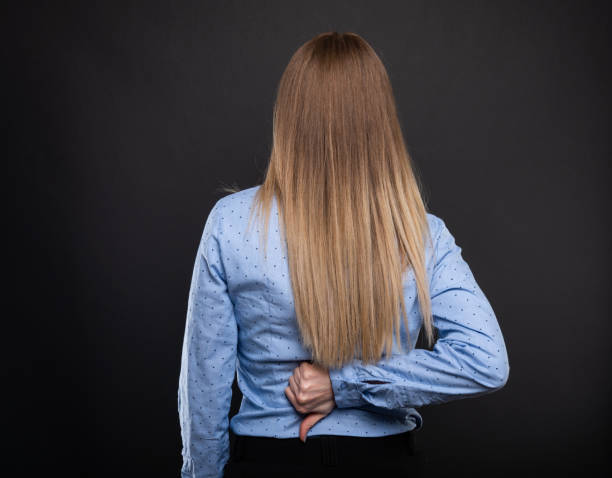 istock Back view of business lady showing thumb down gesture 950712190