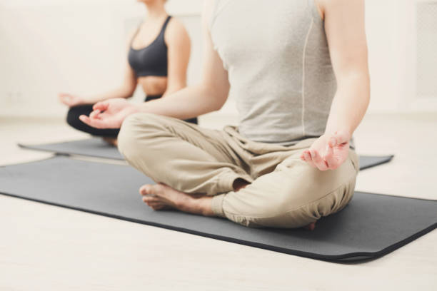 istock Young couple meditating together in studio 950712814
