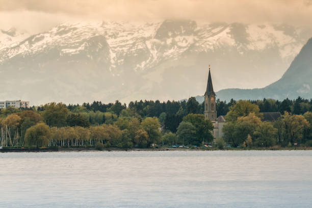 Wettingen-Mehrerau Abbey Wettingen-Mehrerau Abbey in Bregenz on the shore of Lake Constance on a background of snow-capped mountains bregenz stock pictures, royalty-free photos & images