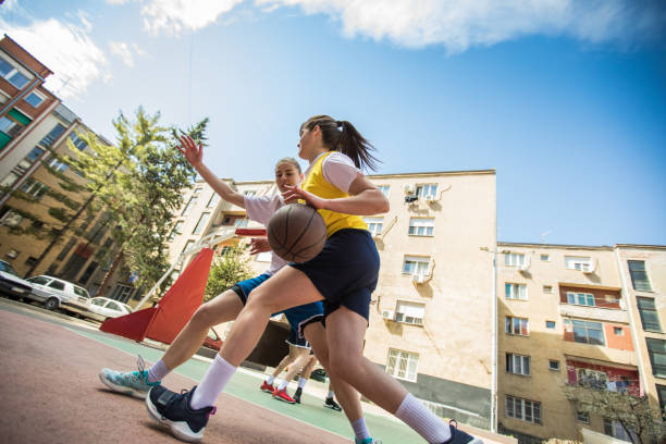 istock Young girls having fun playing basketball 950733182