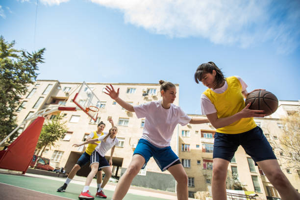 Young girls having fun playing basketball