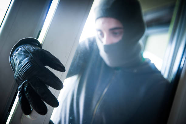 istock Burglar Breaking Into House 950738596