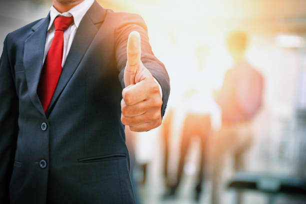 istock Businessman showing thumbs up in office work place 950743250