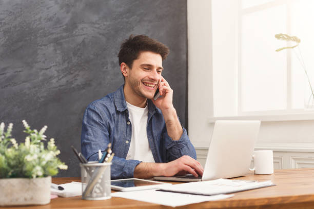 istock Young businessman has mobile talk in modern office 950743518