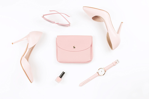 Pale pink female shoes and fashion accessories on white background. Fashion blogger concept flat lay. Top view