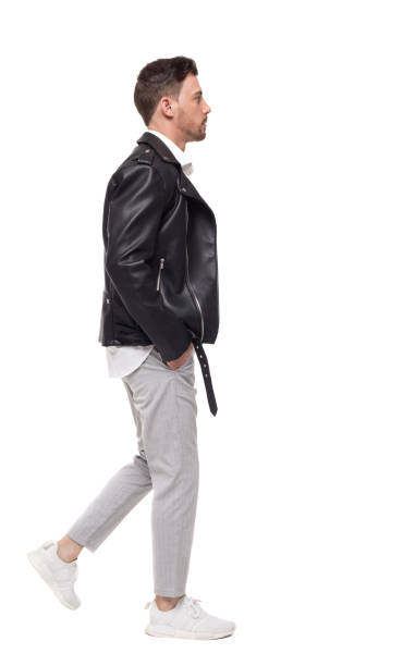 istock Side view of going  handsome man in a leather jacket and trousers. 950746804