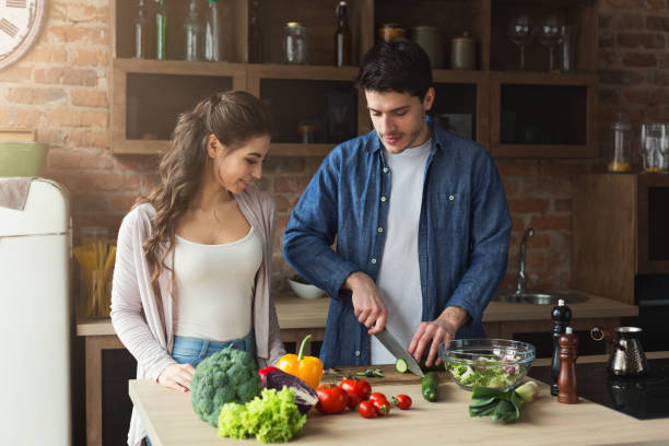 istock Happy couple cooking dinner together 950753380