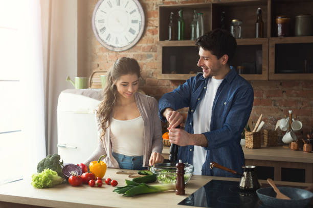istock Happy couple cooking dinner together 950753568