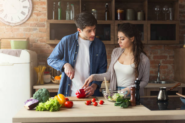 istock Happy couple cooking dinner together 950753770
