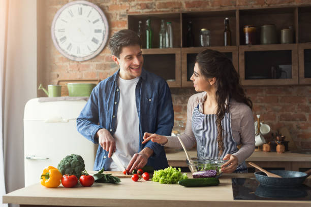 istock Happy couple cooking healthy dinner together 950754246