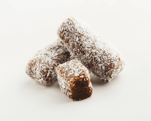 веганский шоколад конфеты изолированы на белом - people snack almond brown стоковые фото и изображения