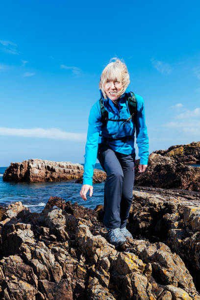istock Senior woman hiking on coastline 950761884