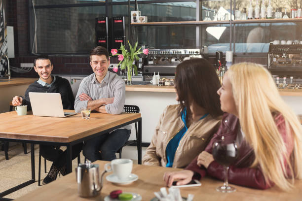 istock Happy young friends drinking coffee at cafe 950762640