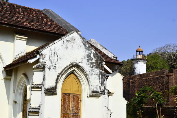 istock Colonial catholic church and lighthouse 950766974