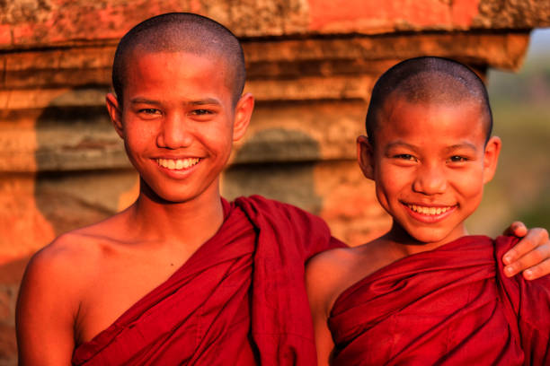 istock Young Buddhist monks resting on the temple, Myanmar 950767934