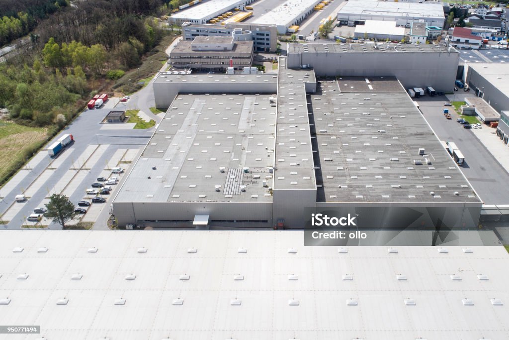 Aerial view of industrial buildings Aerial view of industrial district, large factory and distribution buildings Rooftop Stock Photo