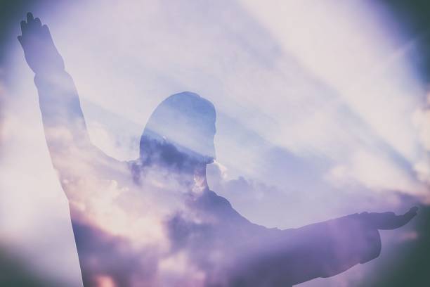 istock Abstract Double Exposure of Jesus Silhouette with Light Beam and Clouds. 950771700