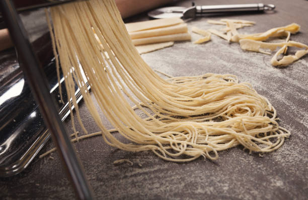 istock Preparing homemade fettuccine on pasta machine 950772038