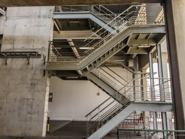 istock metal stairs with rail and cement building 950772974