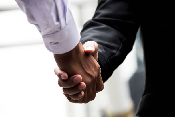 istock Join hands business concept and handshake concept. 950773168
