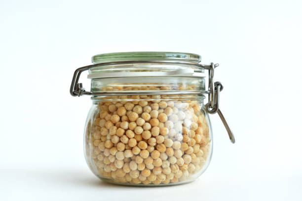 istock Dry peas in a glass transparent jar on a white background 950773546