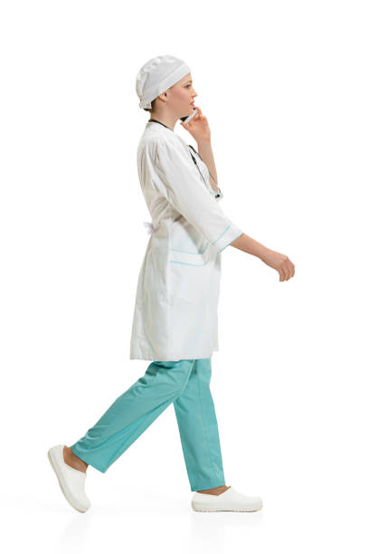 istock Beautiful young woman in white coat posing at studio. Full length studio shot isolated on white 950776712