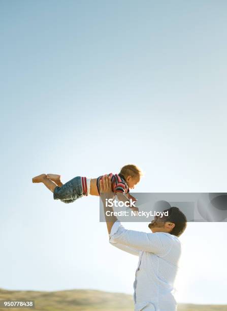 Father And Son Having Fun Outdoors Stock Photo - Download Image Now - Child, Mid-Air, Beach