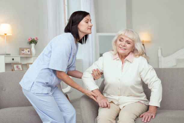 istock Appealing nurse helping elder woman 950779244