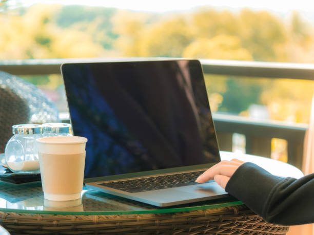 istock business and coffee break concept from freelancer working with computer laptop and drink coffee at outdoor coffee shop in the morning time with soft focus background 950779762