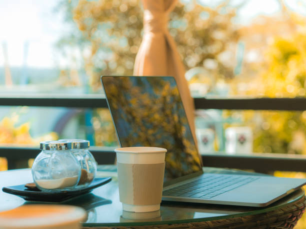 istock business and coffee break concept from freelancer working with computer laptop and drink coffee at outdoor coffee shop in the morning time with soft focus background 950779764