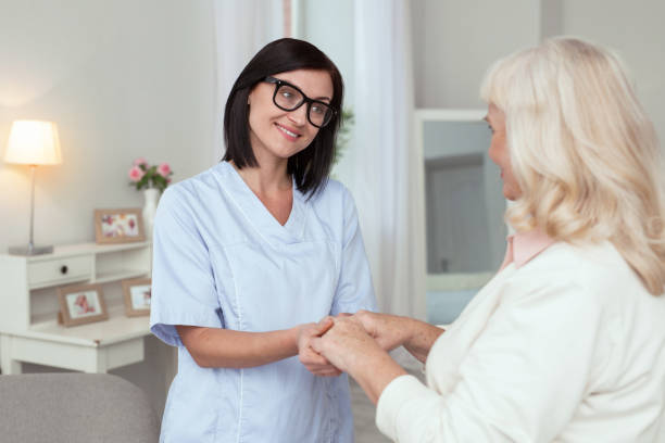 istock Jovial female caregiver providing help 950779854