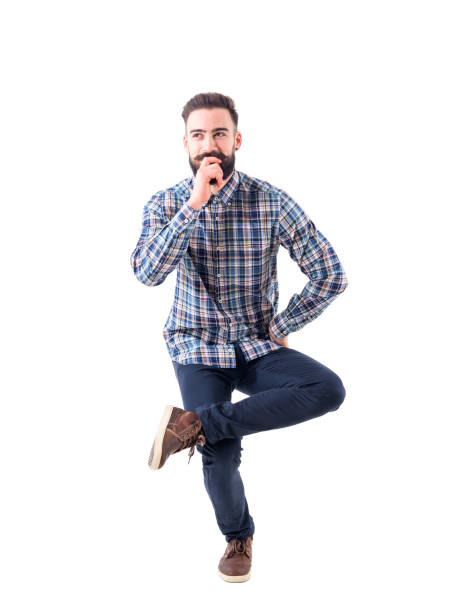 Funny charming bearded young man sitting in mid air on one leg