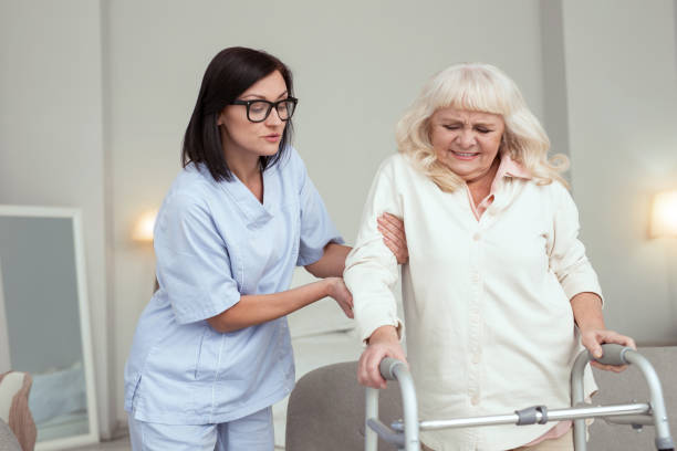 istock Experienced nurse comforting elder woman 950783412