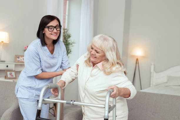 istock Professional nurse giving assistance to elder woman 950783530