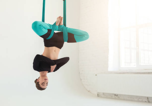 istock Woman practicing fly yoga over white background 950784152
