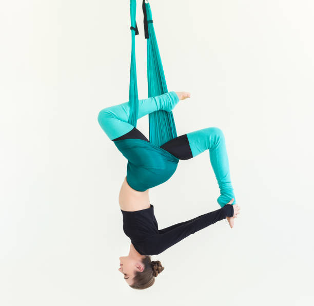 istock Woman practicing fly yoga over white background 950784364