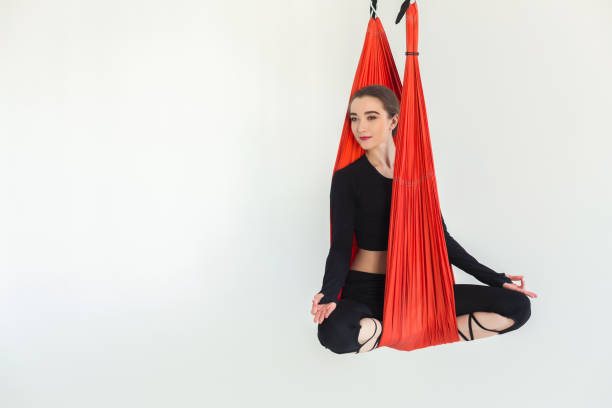 istock Woman practicing fly yoga over white background 950784510