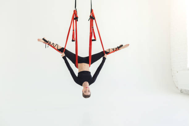 istock Woman practicing fly yoga over white background 950784638