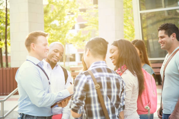 istock College recruiter gives campus tour to potential students. 950784940
