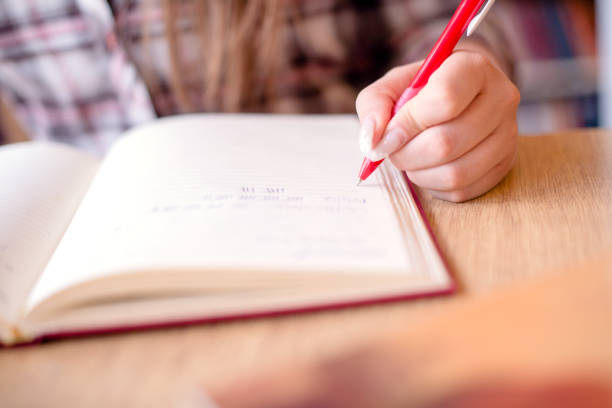 istock Cut out of students hand writting in notebook 950785064