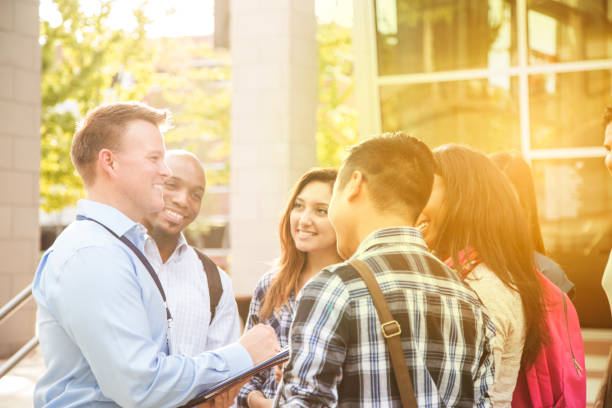 istock College recruiter gives campus tour to potential students. 950787178