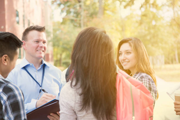 istock College recruiter gives campus tour to potential students. 950787274