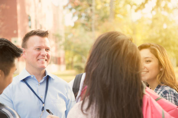 istock College recruiter gives campus tour to potential students. 950787294