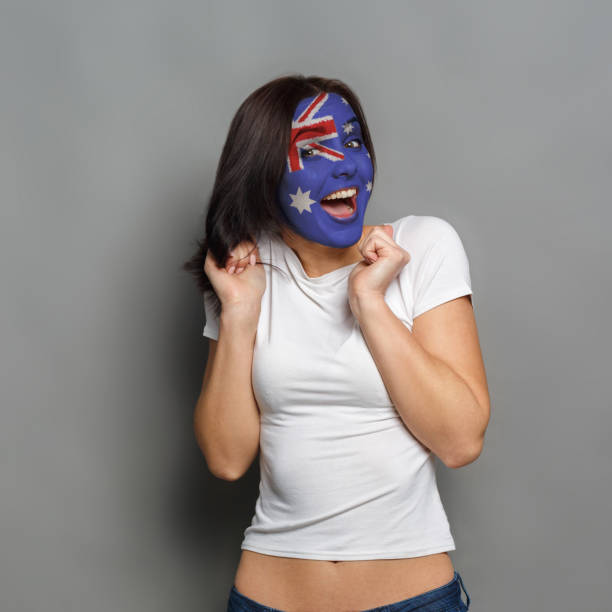 istock Young woman with Australia flag painted on his face 950788180