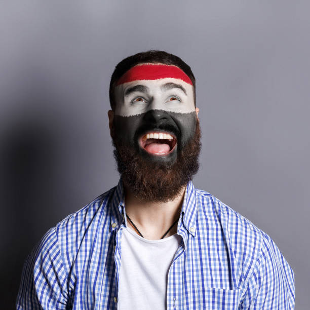 istock Young man with Egypt flag painted on his face 950788654