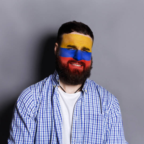 istock Young man with Columbia flag painted on his face 950790898